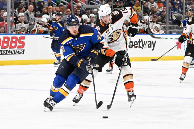 Mar 17, 2024; St. Louis, Missouri, USA; Anaheim Ducks right wing Troy Terry (19) pressures St. Louis Blues right wing Kasperi Kapanen (42) during the second period at Enterprise Center. Mandatory Credit: Jeff Le-USA TODAY Sports