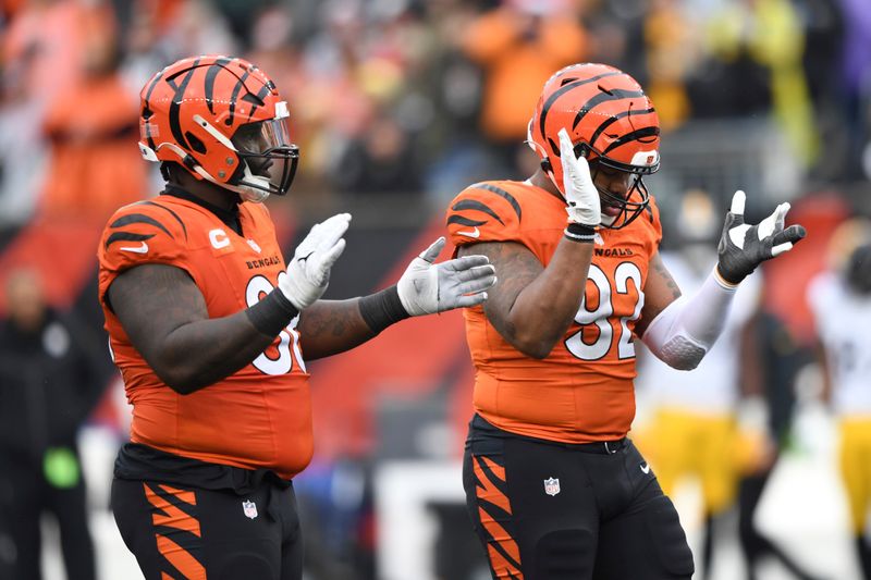 Cincinnati Bengals defensive tackle DJ Reader (98) and defensive tackle BJ Hill (92) during an NFL football game against the Pittsburgh Steelers on Sunday, Nov. 26, 2023, in Cincinnati. (AP Photo/Emilee Chinn)