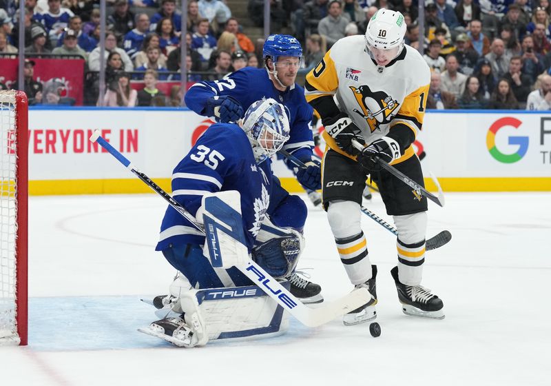 Apr 8, 2024; Toronto, Ontario, CAN; Pittsburgh Penguins left wing Drew O'Connor (10) battles for the puck with Toronto Maple Leafs defenseman Jake McCabe (22) in front of goaltender Ilya Samsonov (35) during the second period at Scotiabank Arena. Mandatory Credit: Nick Turchiaro-USA TODAY Sports