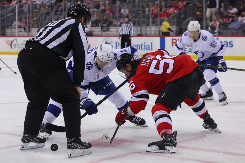 Oct 22, 2024; Newark, New Jersey, USA; Tampa Bay Lightning center Brayden Point (21) and New Jersey Devils left wing Erik Haula (56) face-off during the third period at Prudential Center. Mandatory Credit: Ed Mulholland-Imagn Images