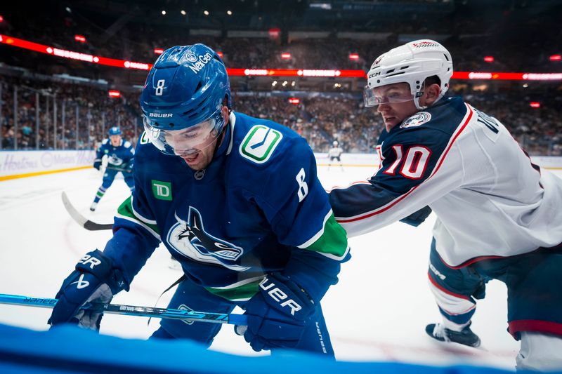 Nov 8, 2025; Vancouver, British Columbia, CAN; Columbus Blue Jackets forward Dmitri Voronkov (10) checks Vancouver Canucks forward Conor Garland (8) in the first period at Rogers Arena. Mandatory Credit: Bob Frid-Imagn Images