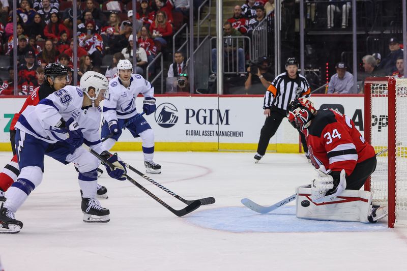 Oct 22, 2024; Newark, New Jersey, USA; New Jersey Devils goaltender Jake Allen (34) makes a save against the Tampa Bay Lightning during the first period at Prudential Center. Mandatory Credit: Ed Mulholland-Imagn Images