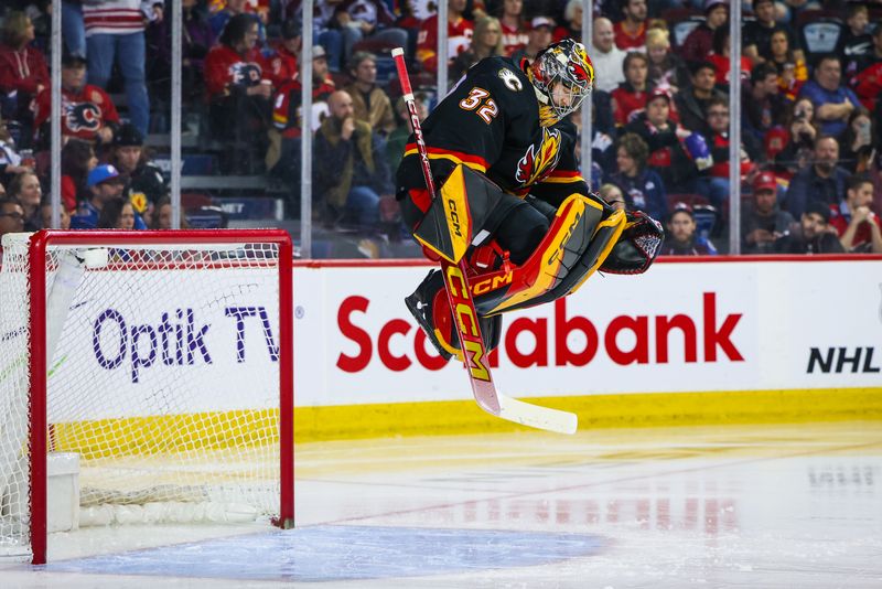 Mar 12, 2024; Calgary, Alberta, CAN; Calgary Flames goaltender Dustin Wolf (32) takes the net for the third period against the Colorado Avalanche at Scotiabank Saddledome. Mandatory Credit: Sergei Belski-USA TODAY Sports