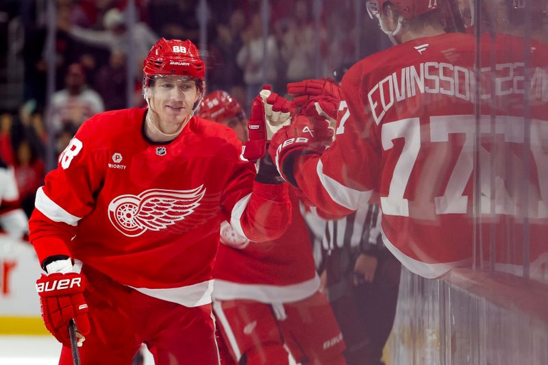 Oct 24, 2024; Detroit, Michigan, USA;  Detroit Red Wings right wing Patrick Kane (88) receives congratulations from teammates after scoring in the third period against the New Jersey Devils at Little Caesars Arena. Mandatory Credit: Rick Osentoski-Imagn Images