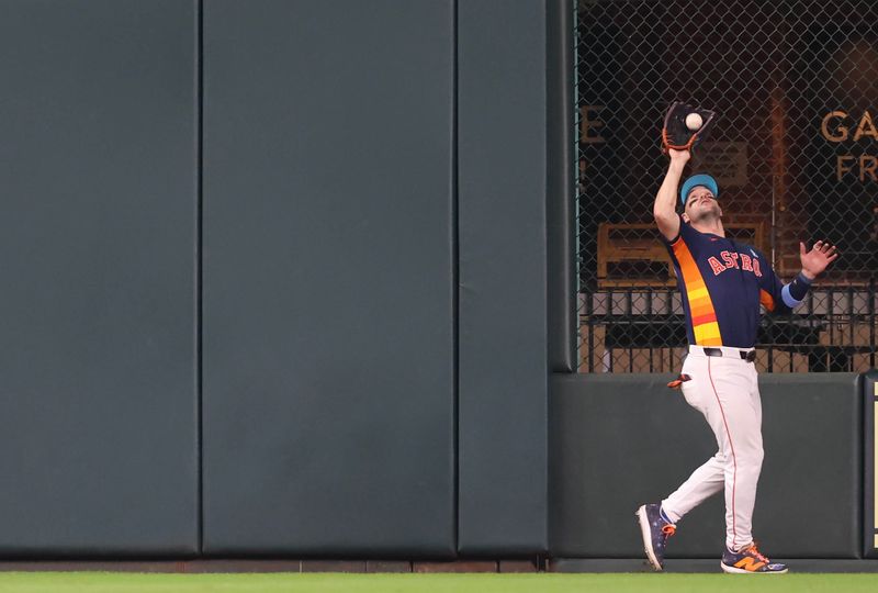 Jun 16, 2024; Houston, Texas, USA; Houston Astros center fielder Chas McCormick (20) catches a Detroit Tigers fly ball in the seventh inning at Minute Maid Park. Mandatory Credit: Thomas Shea-USA TODAY Sports