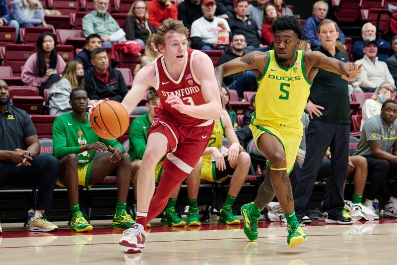 Jan 21, 2023; Stanford, California, USA; Stanford Cardinal guard Michael Jones (13) drives against Oregon Ducks guard Jermaine Couisnard (5) during the first half at Maples Pavilion. Mandatory Credit: Robert Edwards-USA TODAY Sports