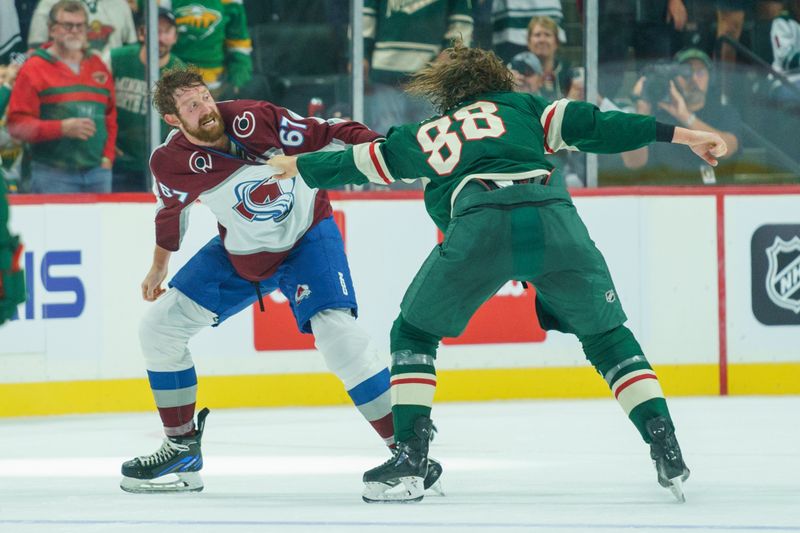 Sep 28, 2023; Saint Paul, Minnesota, USA; Colorado Avalanche defenseman Keaton Middleton (67) and Minnesota Wild left wing Kale Kessy (88) fight in the first period at Xcel Energy Center. Mandatory Credit: Matt Blewett-USA TODAY Sports