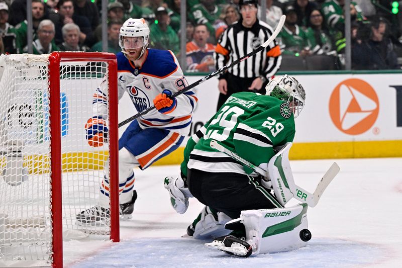 May 21, 2025; Dallas, Texas, USA; Dallas Stars goaltender Jake Oettinger (29) makes a save against Edmonton Oilers center Connor McDavid (97) in the first period during game one of the Western Conference Final of the 2025 Stanley Cup Playoffs at American Airlines Center. Mandatory Credit: Jerome Miron-Imagn Images