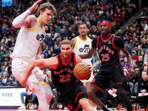 TORONTO, ON - DECEMBER 23: Malachi Flynn #22 of the Toronto Raptors drives against Lauri Markkanen #23 of the Utah Jazz during the first half of their basketball game at the Scotiabank Arena on December 23, 2023 in Toronto, Ontario, Canada. NOTE TO USER: User expressly acknowledges and agrees that, by downloading and/or using this Photograph, user is consenting to the terms and conditions of the Getty Images License Agreement. (Photo by Mark Blinch/Getty Images)