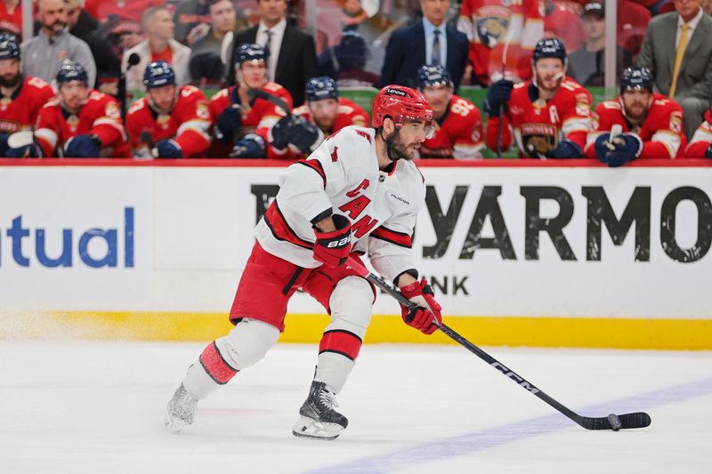 May 24, 2025; Sunrise, Florida, USA; Carolina Hurricanes center Seth Jarvis (24) goes for there puck during the first period against the Florida Panthers in game three of the Eastern Conference Final of the 2025 Stanley Cup Playoffs at Amerant Bank Arena. Mandatory Credit: Sam Navarro-Imagn Images