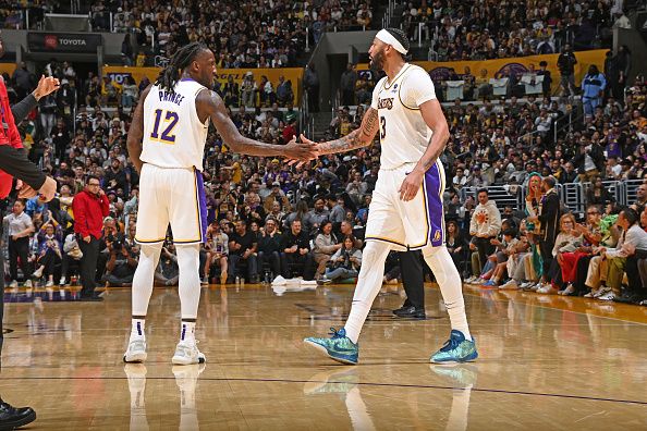 LOS ANGELES, CA - DECEMBER 25: Taurean Prince #12  high fives Anthony Davis #3 of the Los Angeles Lakers during the game against the Boston Celtics on December 25, 2023 at Crypto.Com Arena in Los Angeles, California. NOTE TO USER: User expressly acknowledges and agrees that, by downloading and/or using this Photograph, user is consenting to the terms and conditions of the Getty Images License Agreement. Mandatory Copyright Notice: Copyright 2023 NBAE (Photo by Andrew D. Bernstein/NBAE via Getty Images)