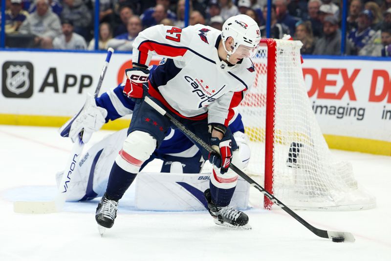 Feb 22, 2024; Tampa, Florida, USA;  Washington Capitals left wing Beck Malenstyn (47) controls the puck in front of the goal against the Tampa Bay Lightning in the second period at Amalie Arena. Mandatory Credit: Nathan Ray Seebeck-USA TODAY Sports