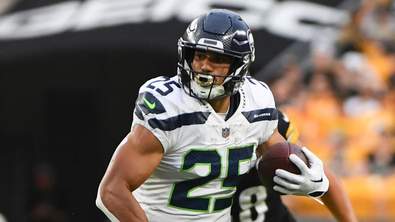 Seattle Seahawks running back Travis Homer (25) runs away from Pittsburgh Steelers linebacker Derrek Tuszka (48) during the first half of an NFL preseason football game, Saturday, Aug. 13, 2022, in Pittsburgh. (AP Photo/Barry Reeger)