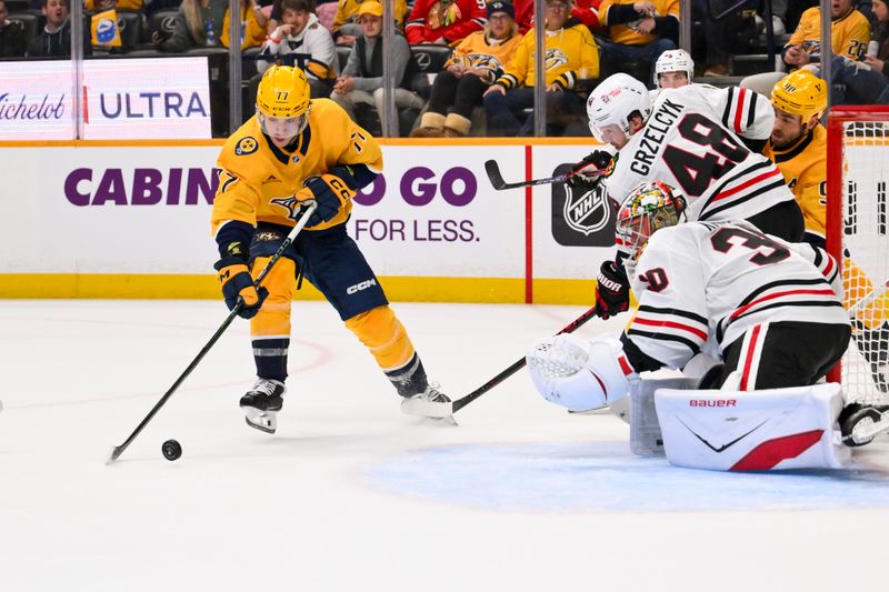 Feb 26, 2026; Nashville, Tennessee, USA;  Chicago Blackhawks goaltender Spencer Knight (30) blocks the shot of Nashville Predators right wing Luke Evangelista (77) during the first period at Bridgestone Arena. Mandatory Credit: Steve Roberts-Imagn Images