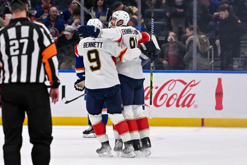 Jan 27, 2024; Elmont, New York, USA; Florida Panthers center Sam Bennett (9) celebrates the game winning goal by Florida Panthers defenseman Oliver Ekman-Larsson (91) against the New York Islanders during overtime at UBS Arena. Mandatory Credit: Dennis Schneidler-USA TODAY Sports