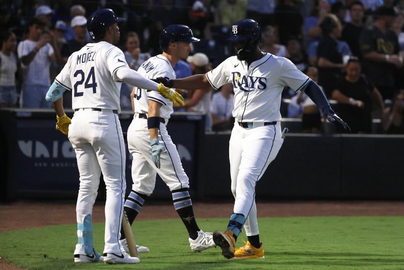 Jun 30, 2025; Tampa, Florida, USA;  Tampa Bay Rays third base Junior Caminero (13) is congratulated after he hit a two-run home run against the Athletics during the fourth inning at George M. Steinbrenner Field. Mandatory Credit: Kim Klement Neitzel-Imagn Images
