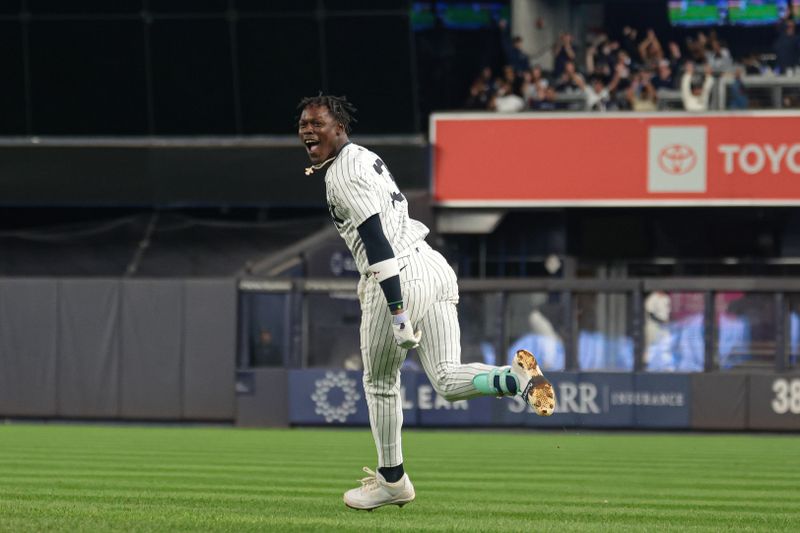 Sep 11, 2024; Bronx, New York, USA; New York Yankees third baseman Jazz Chisholm Jr. (13) celebrates after hitting a game winning RBI single during the eleventh inning against the Kansas City Royals at Yankee Stadium. Mandatory Credit: Vincent Carchietta-Imagn Images