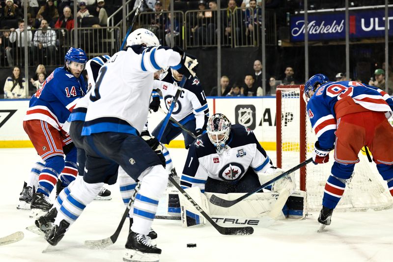 Mar 22, 2026; New York, New York, USA; Winnipeg Jets goaltender Eric Comrie (1) makes a save against the New York Rangers during the second period at Madison Square Garden. Mandatory Credit: John Jones-Imagn Images