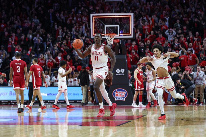 Jan 17, 2024; Piscataway, New Jersey, USA; Rutgers Scarlet Knights center Clifford Omoruyi (11) celebrates with Rutgers Scarlet Knights guard Derek Simpson (0) after defeating the Rutgers Scarlet Knights in overtime at Jersey Mike's Arena. Mandatory Credit: Vincent Carchietta-USA TODAY Sports