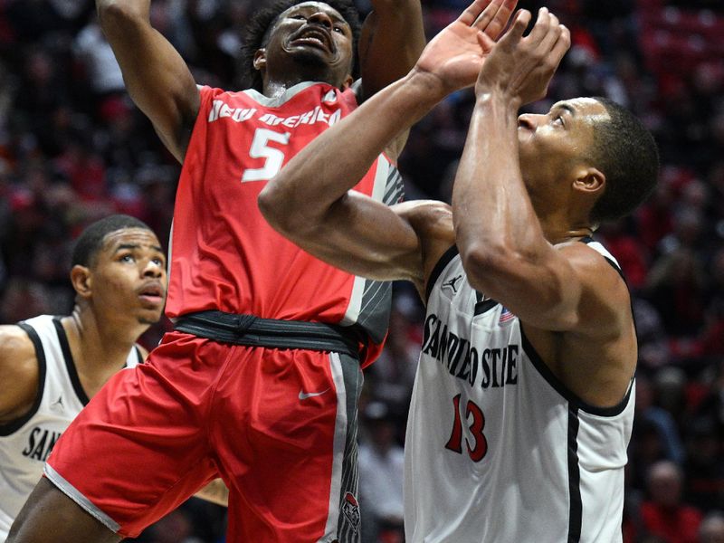 Jan 14, 2023; San Diego, California, USA; New Mexico Lobos guard Jamal Mashburn Jr. (5) shoots the ball over San Diego State Aztecs forward Jaedon LeDee (13) during the second half at Viejas Arena. Mandatory Credit: Orlando Ramirez-USA TODAY Sports