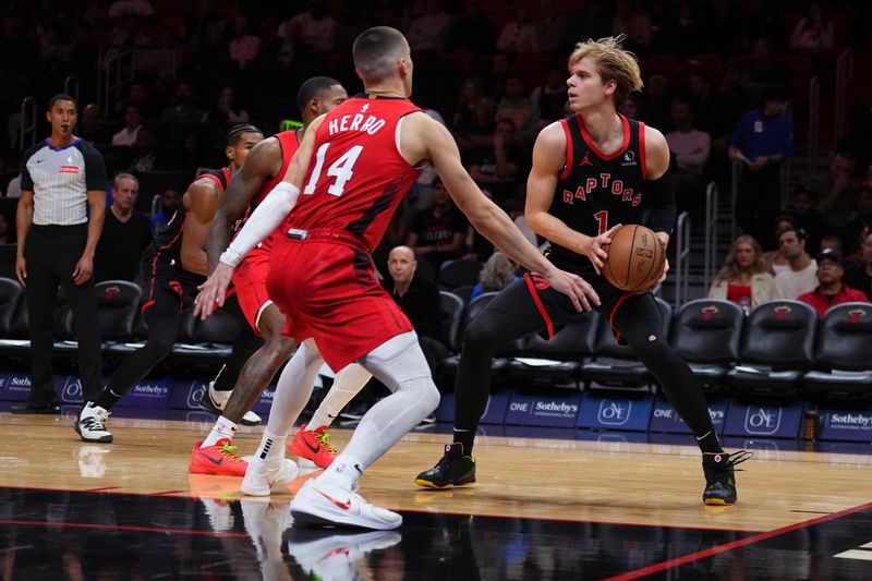MIAMI, FLORIDA - DECEMBER 12: Gradey Dick #1 of the Toronto Raptors dribbles the ball against Tyler Herro #14 of the Miami Heat during the third quarter at Kaseya Center on December 12, 2024 in Miami, Florida. NOTE TO USER: User expressly acknowledges and agrees that, by downloading and or using this Photograph, user is consenting to the terms and conditions of the Getty Images License Agreement. (Photo by Rich Storry/Getty Images)