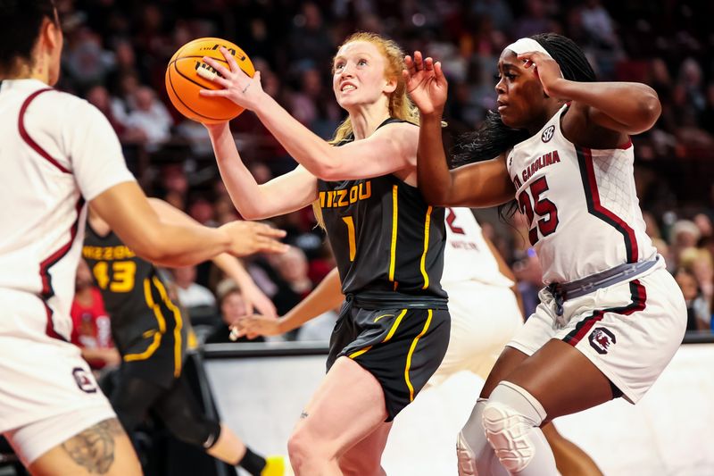 Jan 15, 2023; Columbia, South Carolina, USA; Missouri Tigers guard Lauren Hansen (1) drives past South Carolina Gamecocks guard Raven Johnson (25) in the second half at Colonial Life Arena. Mandatory Credit: Jeff Blake-USA TODAY Sports