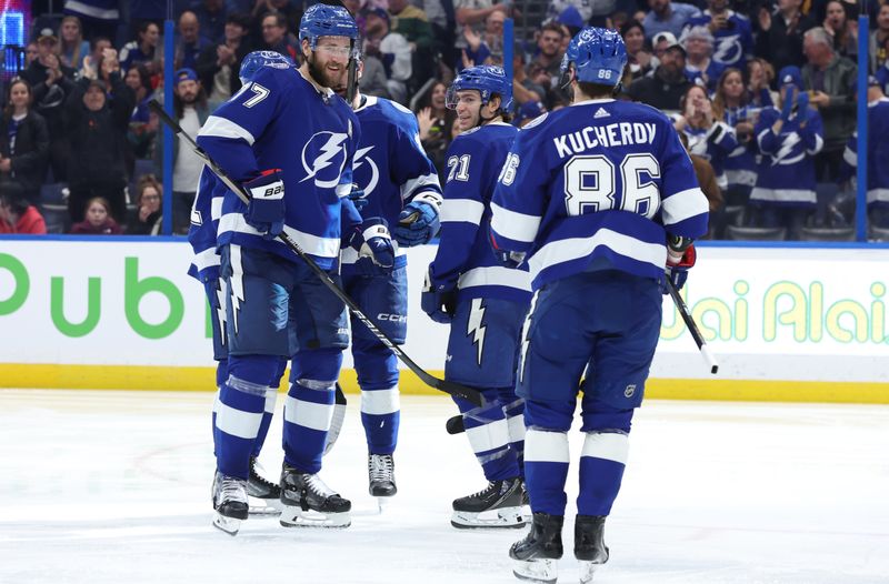 Jan 18, 2024; Tampa, Florida, USA; Tampa Bay Lightning center Steven Stamkos (91) is congratulated by  defenseman Victor Hedman (77) , center Brayden Point (21) and right wing Nikita Kucherov (86) against the Minnesota Wild during the third period at Amalie Arena. Mandatory Credit: Kim Klement Neitzel-USA TODAY Sports