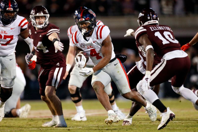 Nov 23, 2023; Starkville, Mississippi, USA; Mississippi Rebels running back Quinshon Judkins (4) runs the ball as Mississippi State Bulldogs linebacker Jett Johnson (44) and defensive back Corey Ellington (10) attempt to make the tackle during the second half at Davis Wade Stadium at Scott Field. Mandatory Credit: Petre Thomas-USA TODAY Sports