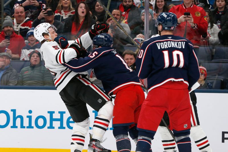 Feb 4, 2026; Columbus, Ohio, USA; Columbus Blue Jackets defenseman Dante Fabbro (15) and Chicago Blackhawks defenseman Connor Murphy (5) scrum during the third period at Nationwide Arena. Mandatory Credit: Russell LaBounty-Imagn Images