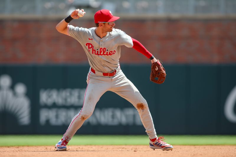 Jul 7, 2024; Atlanta, Georgia, USA; Philadelphia Phillies shortstop Trea Turner (7) throws a runner out at first against the Atlanta Braves in the eighth inning at Truist Park. Mandatory Credit: Brett Davis-USA TODAY Sports