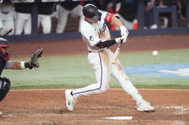 Sep 11, 2025; Miami, Florida, USA;  Miami Marlins first baseman Eric Wagaman (33) hits a two-run double in the eighth inning against the Washington Nationals at loanDepot Park. Mandatory Credit: Jim Rassol-Imagn Images