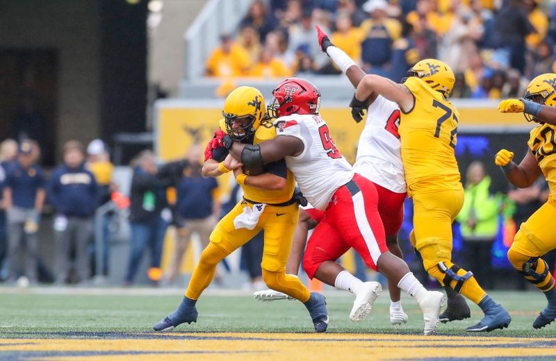 Sep 23, 2023; Morgantown, West Virginia, USA; Texas Tech Red Raiders defensive lineman Jaylon Hutchings (95) sacks West Virginia Mountaineers quarterback Nicco Marchiol (8) during the first quarter at Mountaineer Field at Milan Puskar Stadium. Mandatory Credit: Ben Queen-USA TODAY Sports