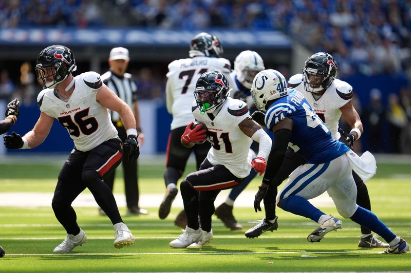 Houston Texans running back Dameon Pierce (31) runs against Indianapolis Colts linebacker Zaire Franklin (44) during the second half of an NFL football game, Sunday, Sept. 8, 2024, in Indianapolis. (AP Photo/Michael Conroy)