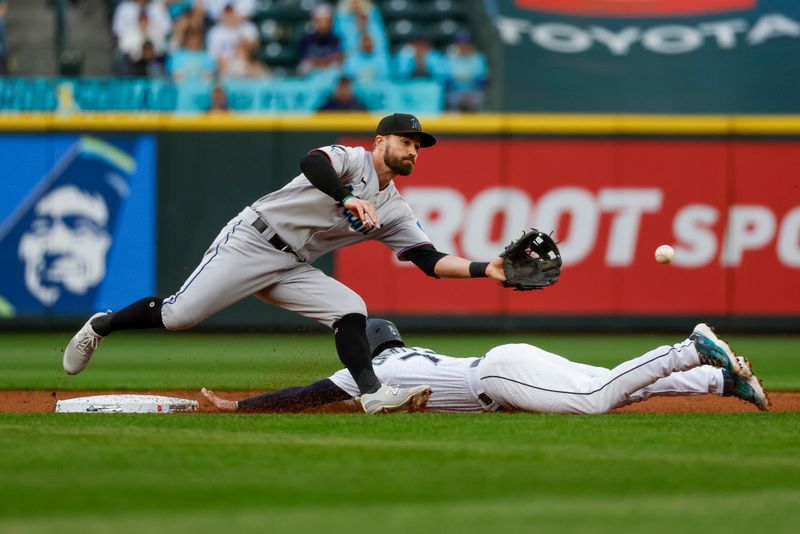 Jun 13, 2023; Seattle, Washington, USA; Seattle Mariners second baseman Jose Caballero (76) steals second base before Miami Marlins shortstop Jon Berti (5) can field the throw during the second inning at T-Mobile Park. Mandatory Credit: Joe Nicholson-USA TODAY Sports