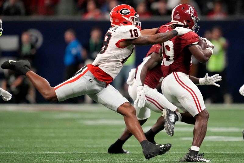 Dec 2, 2023; Atlanta, GA, USA; Georgia Bulldogs linebacker Xavian Sorey Jr. (18) makes a tackle on Alabama Crimson Tide wide receiver Kendrick Law (19) during the second half in the SEC Championship game at Mercedes-Benz Stadium. Mandatory Credit: Dale Zanine-USA TODAY Sports