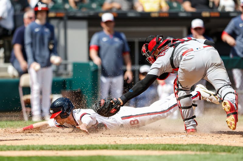 Jul 9, 2023; Chicago, Illinois, USA; Chicago White Sox shortstop Zach Remillard (28) scores against St. Louis Cardinals catcher Willson Contreras (40) during the eight inning at Guaranteed Rate Field. Mandatory Credit: Kamil Krzaczynski-USA TODAY Sports