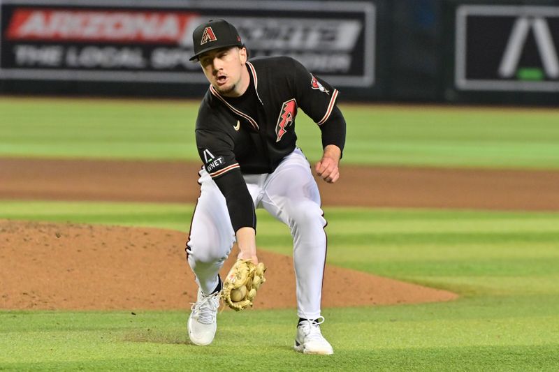 May 27, 2023; Phoenix, Arizona, USA;  Arizona Diamondbacks relief pitcher Kyle Nelson (24) fields a bunt against the Boston Red Sox in the fourth inning at Chase Field. Mandatory Credit: Matt Kartozian-USA TODAY Sports