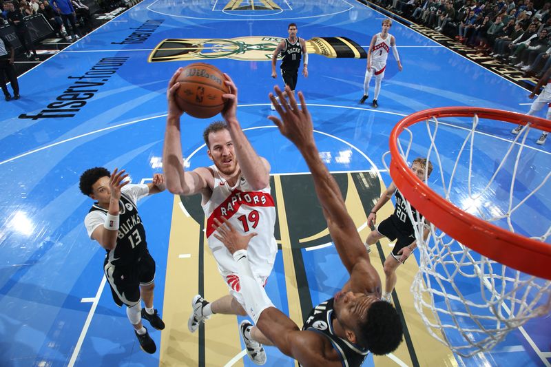 MILWAUKEE, WI - NOVEMBER 12:  Jakob Poeltl #19 of the Toronto Raptors shoots the ball during the game against the Milwaukee Bucks  during the Emirates NBA Cup game on November 12, 2024 at Fiserv Forum Center in Milwaukee, Wisconsin. NOTE TO USER: User expressly acknowledges and agrees that, by downloading and or using this Photograph, user is consenting to the terms and conditions of the Getty Images License Agreement. Mandatory Copyright Notice: Copyright 2024 NBAE (Photo by Gary Dineen/NBAE via Getty Images).