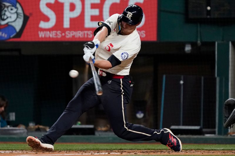 Jul 5, 2024; Arlington, Texas, USA; Texas Rangers shortstop Corey Seager (5) hits a two-run RBI double during the third inning against the Tampa Bay Rays at Globe Life Field. Mandatory Credit: Raymond Carlin III-USA TODAY Sports