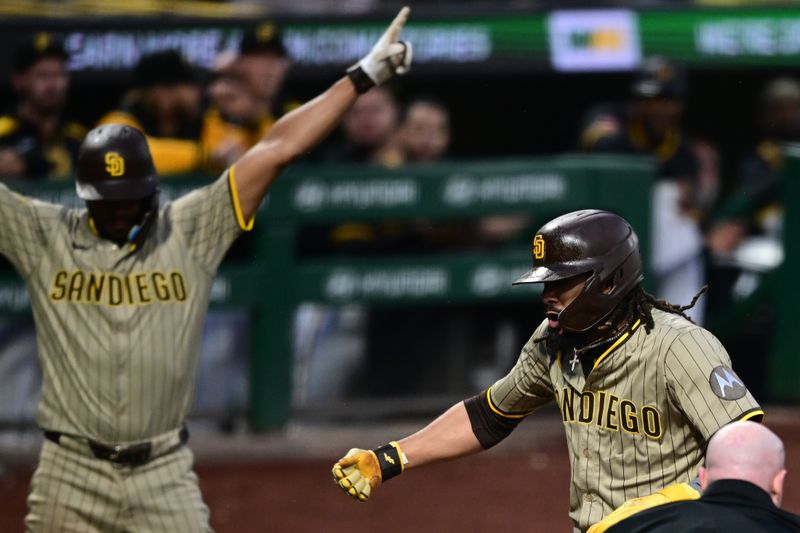 May 3, 2025; Pittsburgh, Pennsylvania, USA; San Diego Padres right fielder Fernando Tatis Jr. (23) celebrates after scoring a run after a wild pitch by Pittsburgh Pirates relief pitcher David Bednar (51) during the ninth inning at PNC Park. Mandatory Credit: David Dermer-Imagn Images