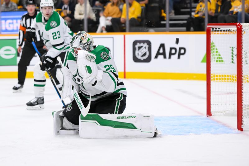 Oct 10, 2024; Nashville, Tennessee, USA; Dallas Stars goaltender Jake Oettinger (29) has the puck go off his helmet against the Nashville Predators during the first period at Bridgestone Arena. Mandatory Credit: Steve Roberts-Imagn Images