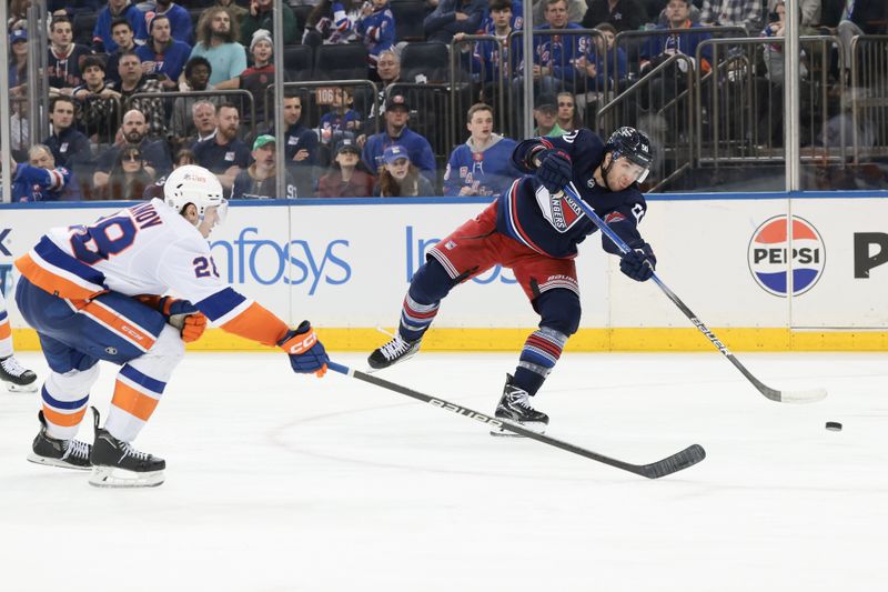 Mar 17, 2024; New York, New York, USA; New York Rangers left wing Will Cuylle (50) shoots the puck as New York Islanders defenseman Alexander Romanov (28) defends during the second period at Madison Square Garden. Mandatory Credit: Vincent Carchietta-USA TODAY Sports