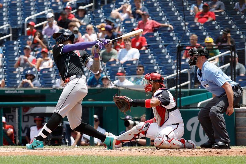 Jun 20, 2024; Washington, District of Columbia, USA; Arizona Diamondbacks outfielder Lourdes Gurriel Jr. (12) singles against the Washington Nationals during the third inning at Nationals Park. Mandatory Credit: Geoff Burke-USA TODAY Sports