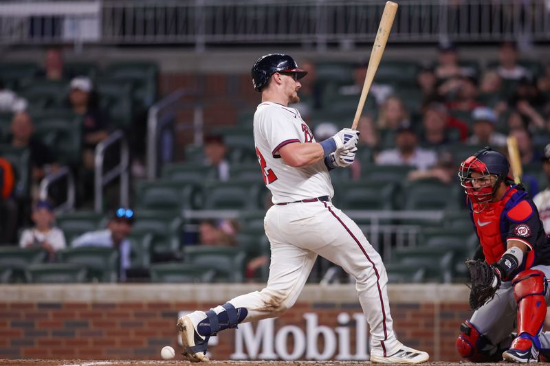 May 14, 2025; Atlanta, Georgia, USA; Atlanta Braves catcher Sean Murphy (12) is hit by a pitch against the Washington Nationals in the eighth inning at Truist Park. Mandatory Credit: Brett Davis-Imagn Images
