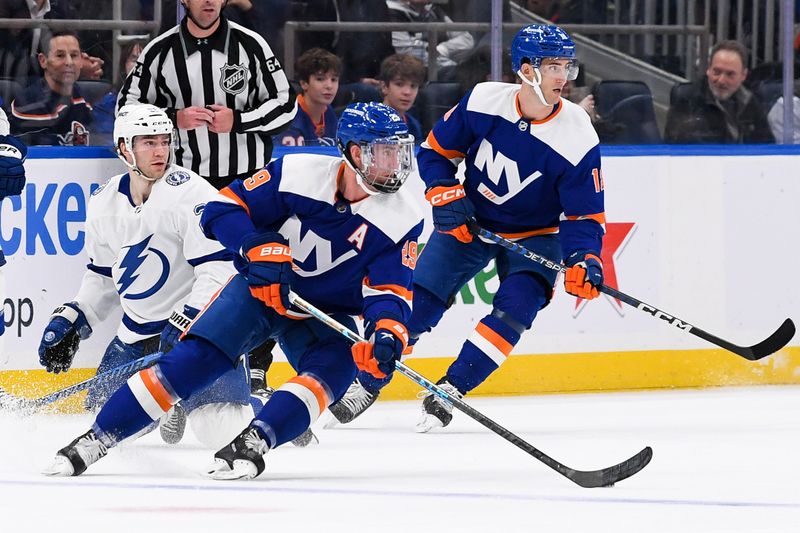 Apr 6, 2023; Elmont, New York, USA; New York Islanders center Brock Nelson (29) keeps the puck in his zone against the Tampa Bay Lightning during the first period at UBS Arena. Mandatory Credit: Dennis Schneidler-USA TODAY Sports
