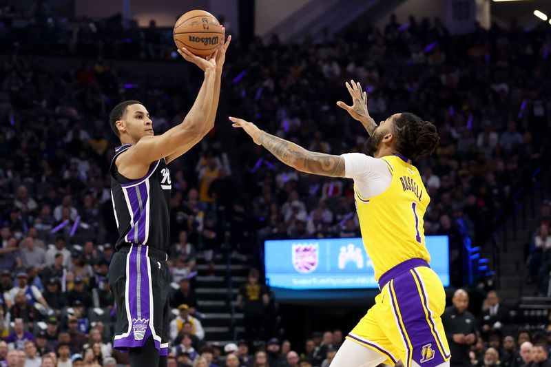 SACRAMENTO, CALIFORNIA - MARCH 13: Keegan Murray #13 of the Sacramento Kings shoots over D'Angelo Russell #1 of the Los Angeles Lakers in the first half at Golden 1 Center on March 13, 2024 in Sacramento, California. NOTE TO USER: User expressly acknowledges and agrees that, by downloading and or using this photograph, User is consenting to the terms and conditions of the Getty Images License Agreement.  (Photo by Ezra Shaw/Getty Images)