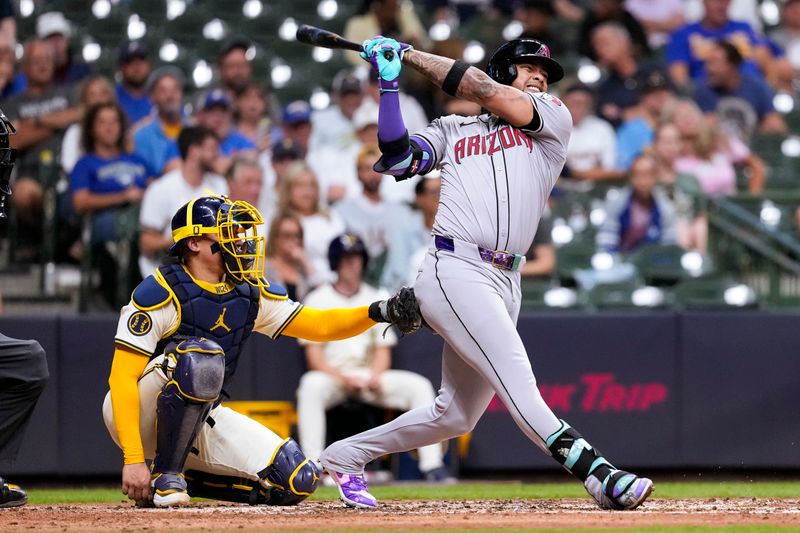 Sep 19, 2024; Milwaukee, Wisconsin, USA;  Arizona Diamondbacks second baseman Ketel Marie (4) hits an RBI single during the fifth inning against the Milwaukee Brewers at American Family Field. Mandatory Credit: Jeff Hanisch-Imagn Images