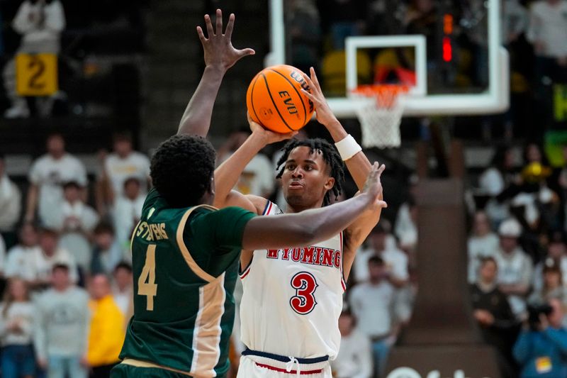 Jan 27, 2024; Laramie, Wyoming, USA; Wyoming Cowboys guard Sam Griffin (3) shoots against Colorado State Rams forward Isaiah Stevens (4) during overtime at Arena-Auditorium. Mandatory Credit: Troy Babbitt-USA TODAY Sports