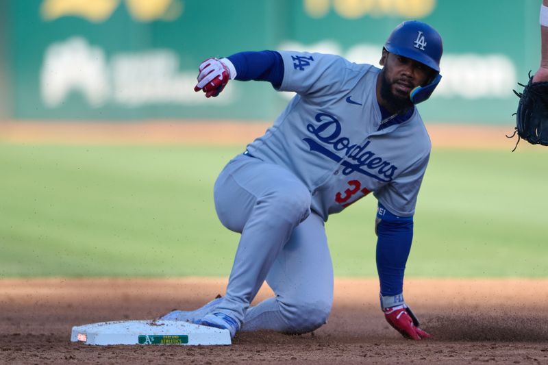 Aug 3, 2024; Oakland, California, USA; Los Angeles Dodgers outfielder Teoscar Hernandez (37) slides into second base with a double against the Oakland Athletics during the third inning at Oakland-Alameda County Coliseum. Mandatory Credit: Robert Edwards-USA TODAY Sports