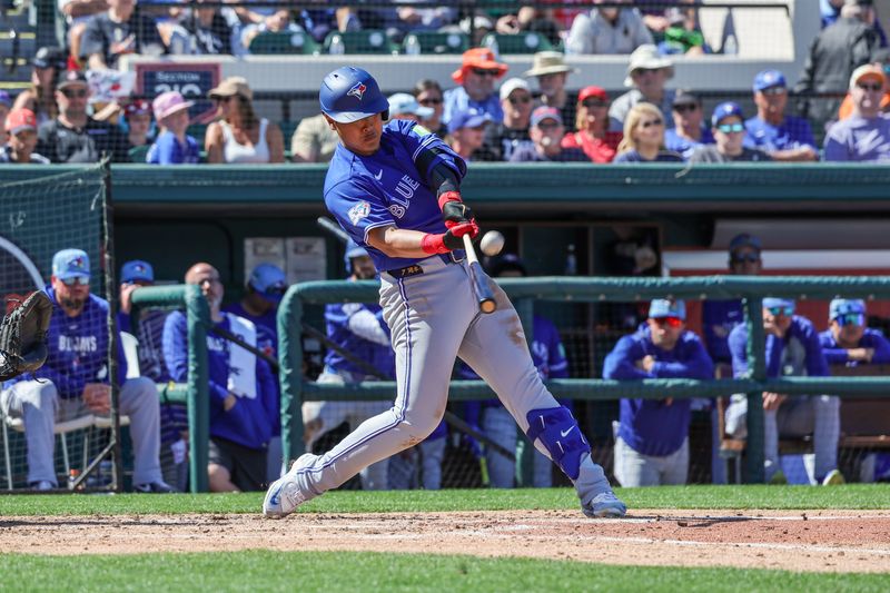 Feb 25, 2026; Lakeland, Florida, USA; Toronto Blue Jays third baseman Kazuma Okamoto (7) doubles during the fourth inning against the Detroit Tigers at Publix Field at Joker Marchant Stadium. Mandatory Credit: Mike Watters-Imagn Images